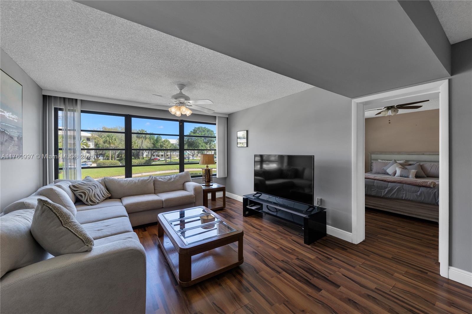 6025 Balboa Circle, Unit 204 Boca Raton, FL 33433 - Photo 16 of 38 a living room with furniture and a flat screen tv