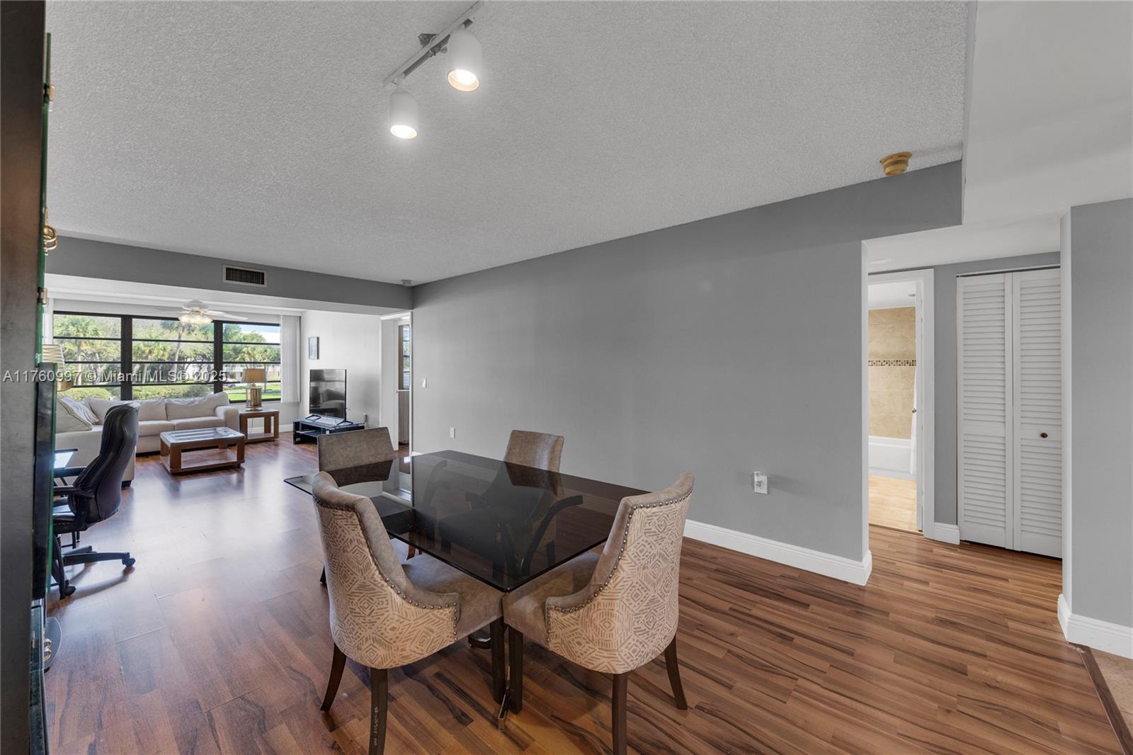 6025 Balboa Circle, Unit 204 Boca Raton, FL 33433 - Photo 19 of 38 a living room with furniture and a wooden floor