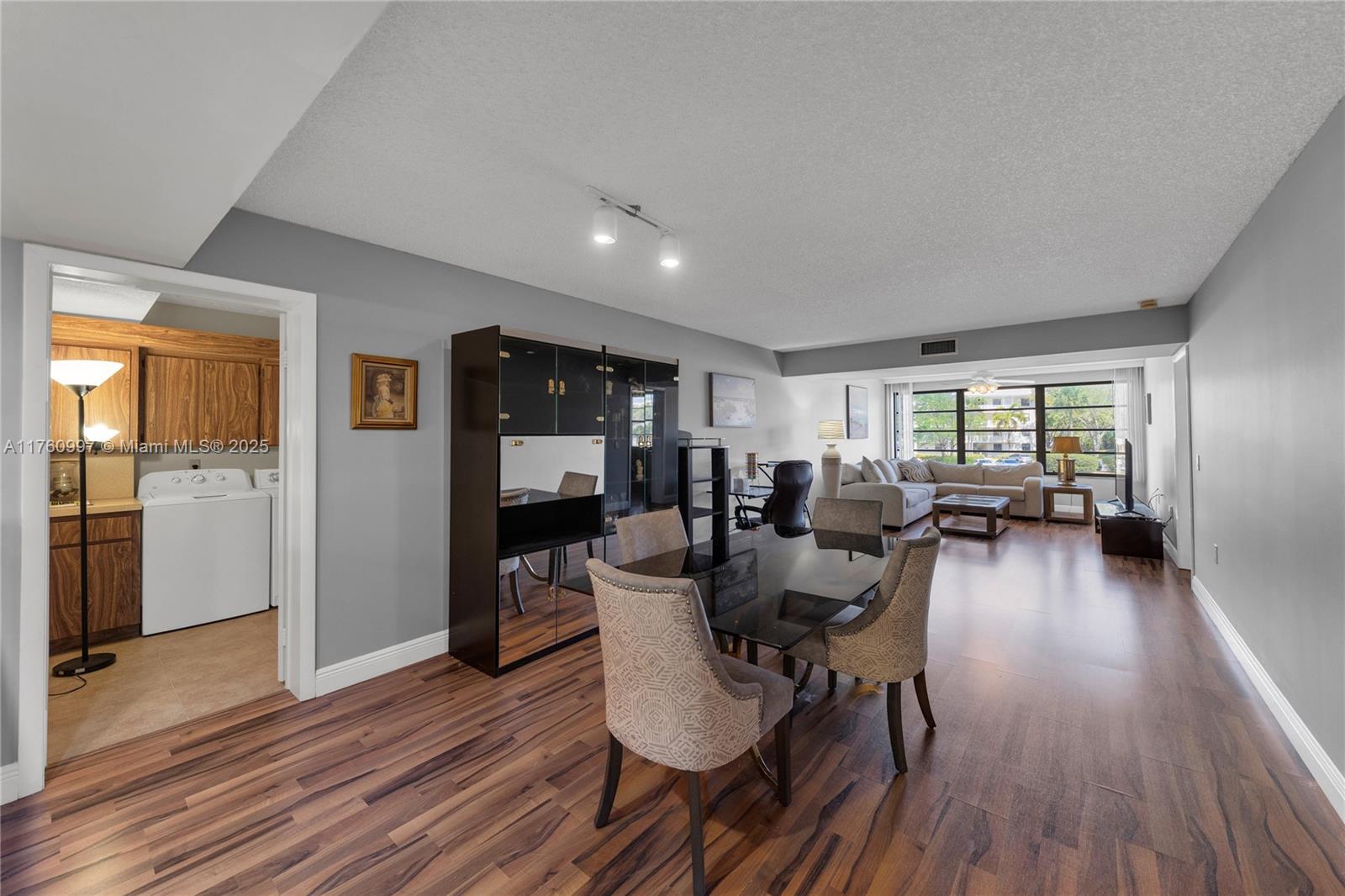 6025 Balboa Circle, Unit 204 Boca Raton, FL 33433 - Photo 20 of 38 a view of a dining room with furniture window and wooden floor