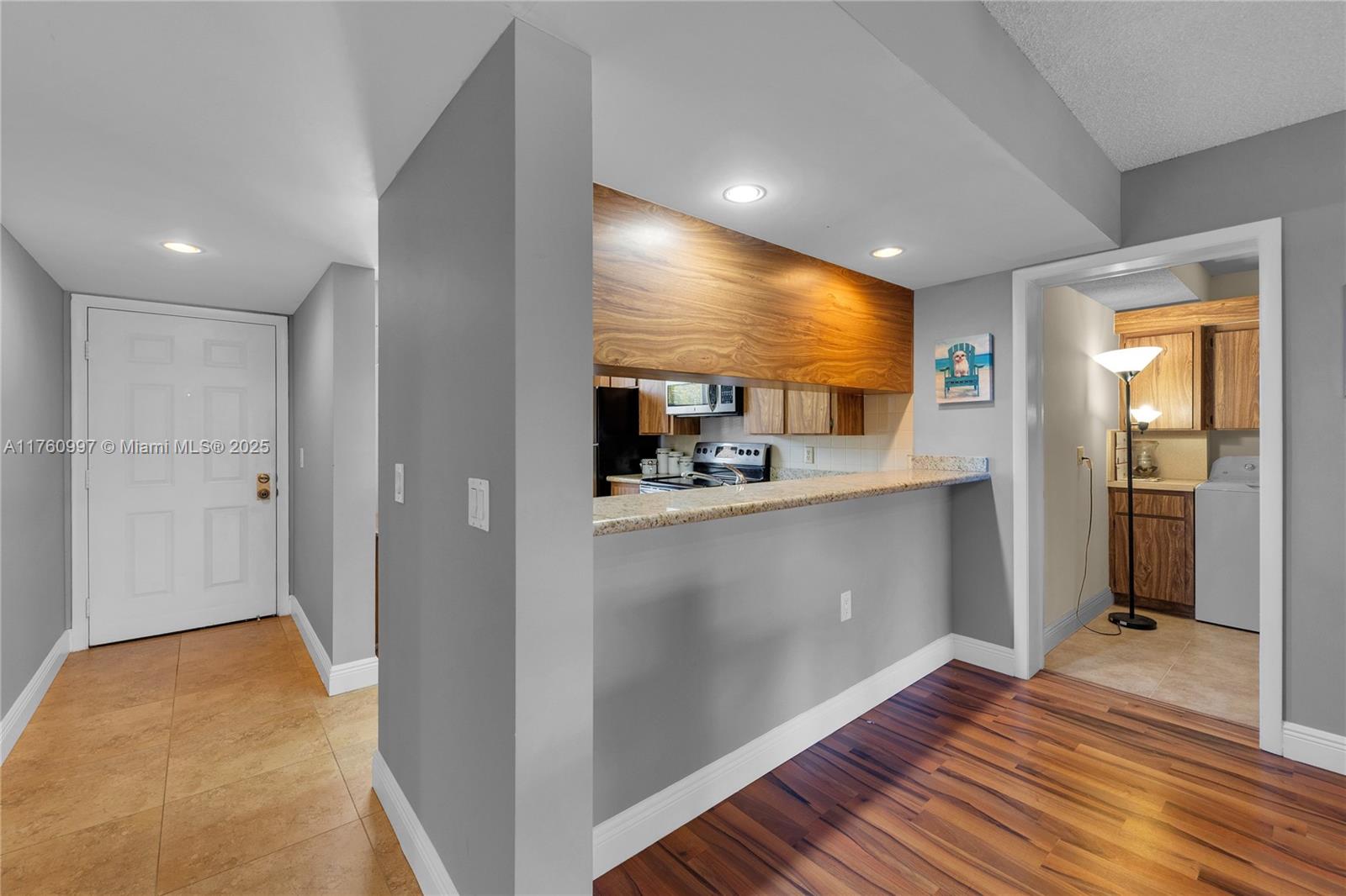 6025 Balboa Circle, Unit 204 Boca Raton, FL 33433 - Photo 21 of 38 a view of a hallway with wooden shelves