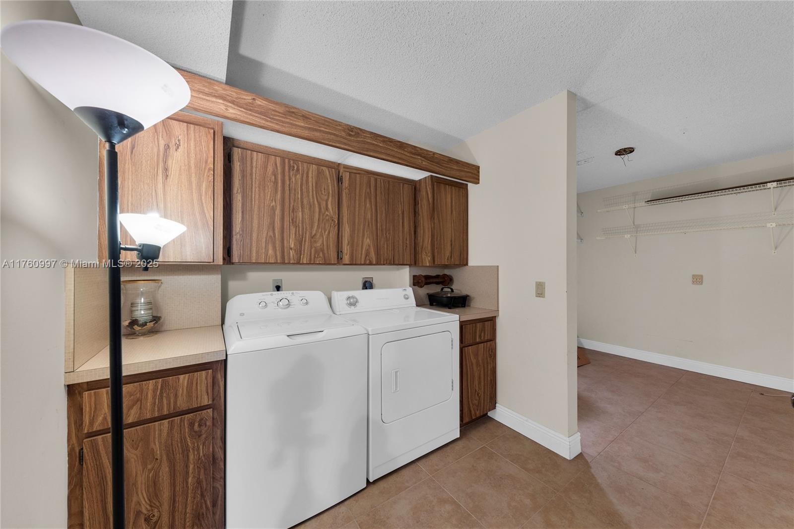 6025 Balboa Circle, Unit 204 Boca Raton, FL 33433 - Photo 22 of 38 a utility room with dryer and washer