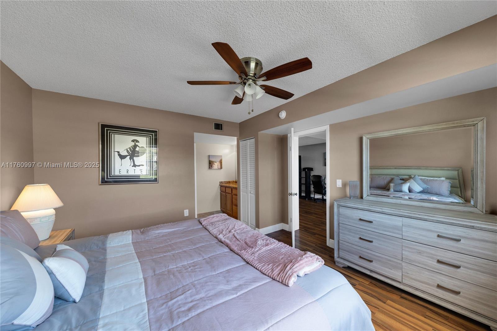 6025 Balboa Circle, Unit 204 Boca Raton, FL 33433 - Photo 25 of 38 a bedroom with a large bed and a dresser