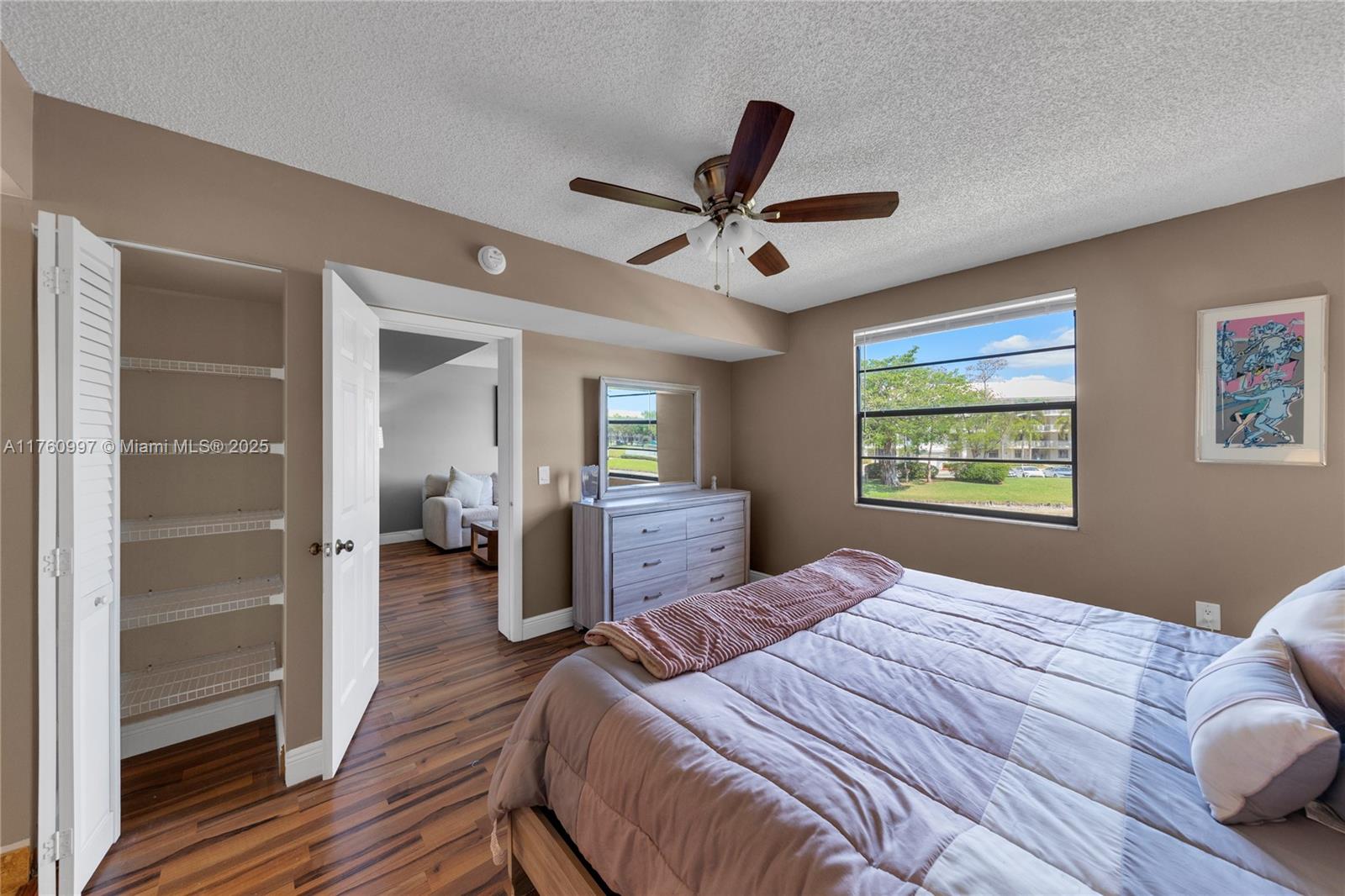 6025 Balboa Circle, Unit 204 Boca Raton, FL 33433 - Photo 26 of 38 a bedroom with a bed and wooden floor