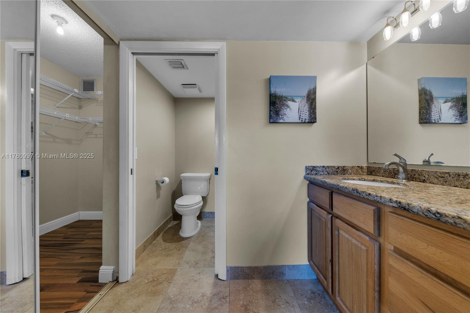 6025 Balboa Circle, Unit 204 Boca Raton, FL 33433 - Photo 27 of 38 a bathroom with a granite countertop sink toilet and shower