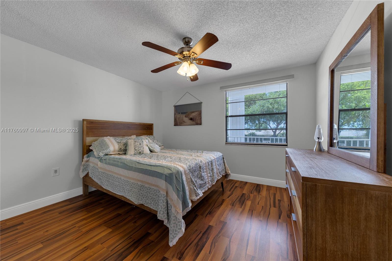 6025 Balboa Circle, Unit 204 Boca Raton, FL 33433 - Photo 28 of 38 a bedroom with a bed and a window