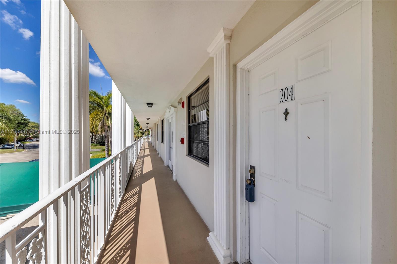 6025 Balboa Circle, Unit 204 Boca Raton, FL 33433 - Photo 3 of 38 a view of a hallway with wooden floor and staircase