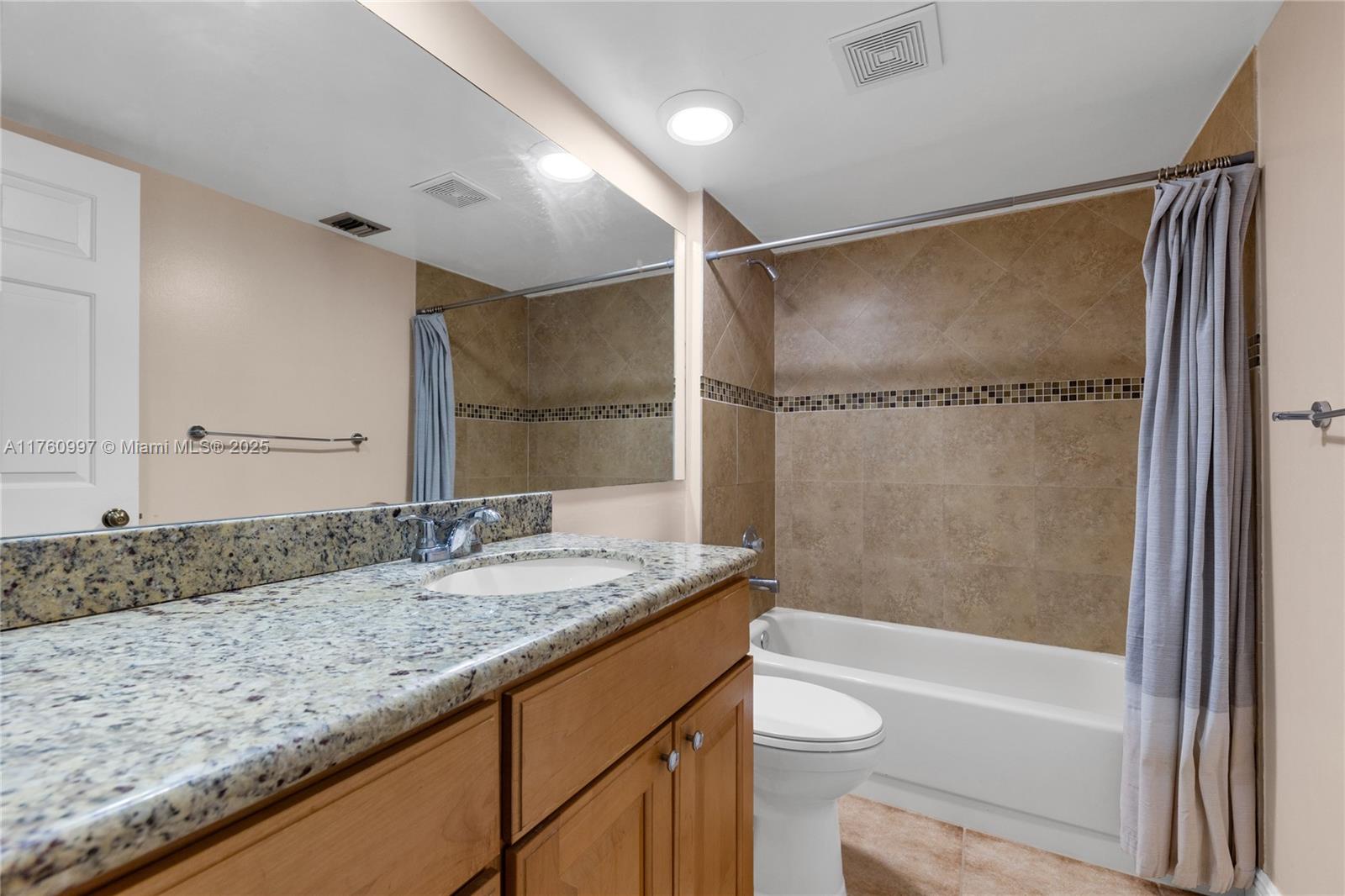 6025 Balboa Circle, Unit 204 Boca Raton, FL 33433 - Photo 32 of 38 a bathroom with a granite countertop sink toilet and shower