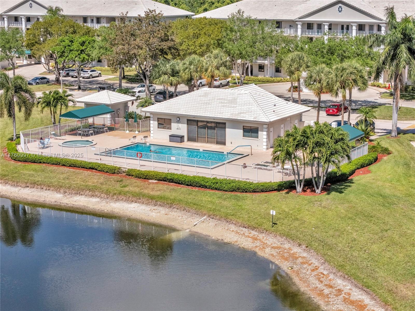 6025 Balboa Circle, Unit 204 Boca Raton, FL 33433 - Photo 38 of 38 an aerial view of residential houses with yard and swimming pool