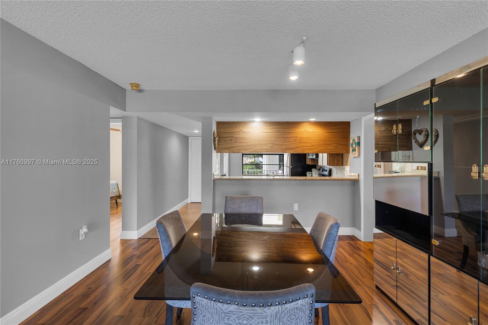 6025 Balboa Circle, Unit 204 Boca Raton, FL 33433 - Photo 9 of 38 a kitchen with stainless steel appliances granite countertop a sink refrigerator and cabinets
