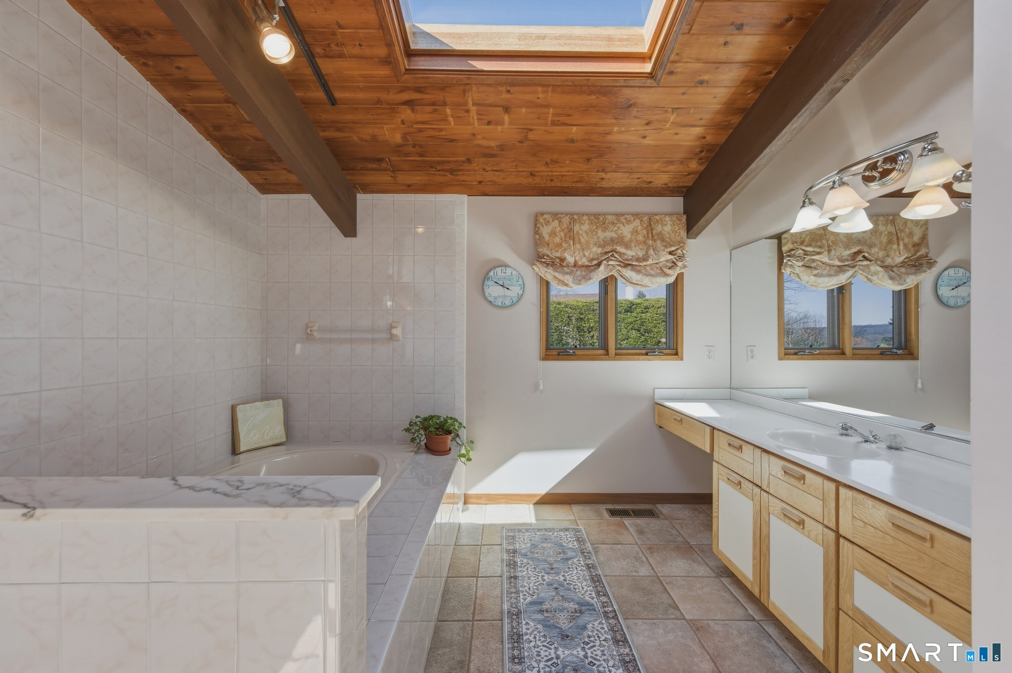 279 Mooreland Road Berlin, CT 06037 - Photo 19 of 40 Cathedral tongue and groove cedar wood ceiling, tile floor. Soaking tub and separate shower, large vanity area. Leads to large walk in closet.