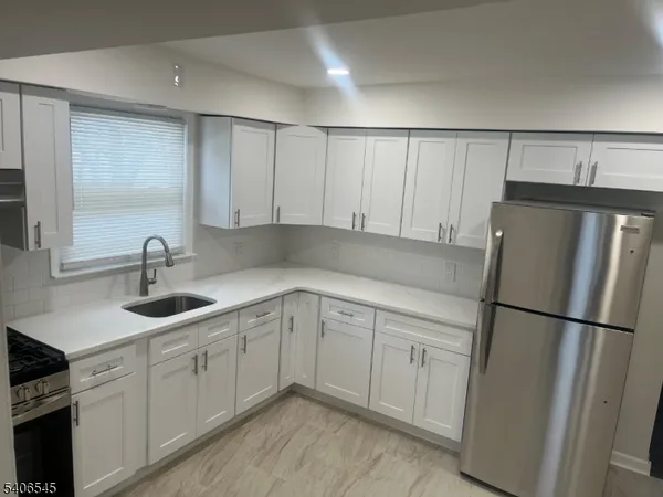 a kitchen with a sink and refrigerator