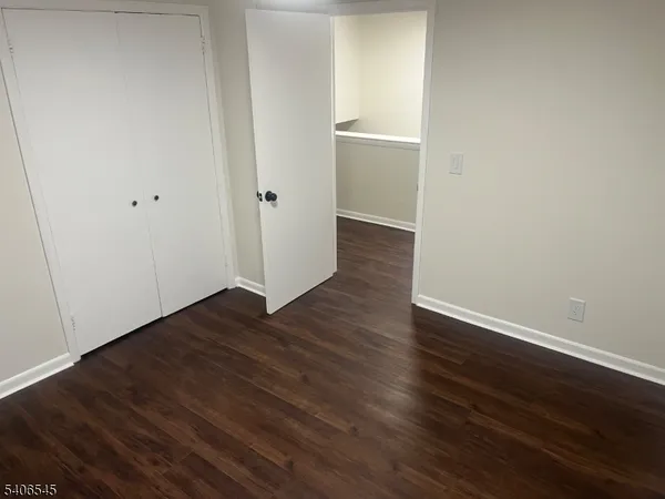 a view of a room with wooden floor