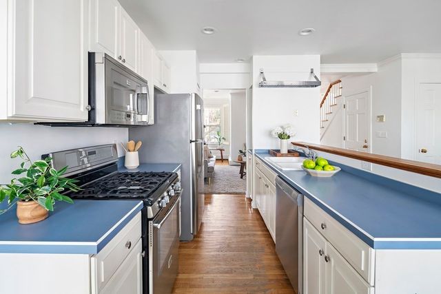 a kitchen with stainless steel appliances a stove a sink and a refrigerator