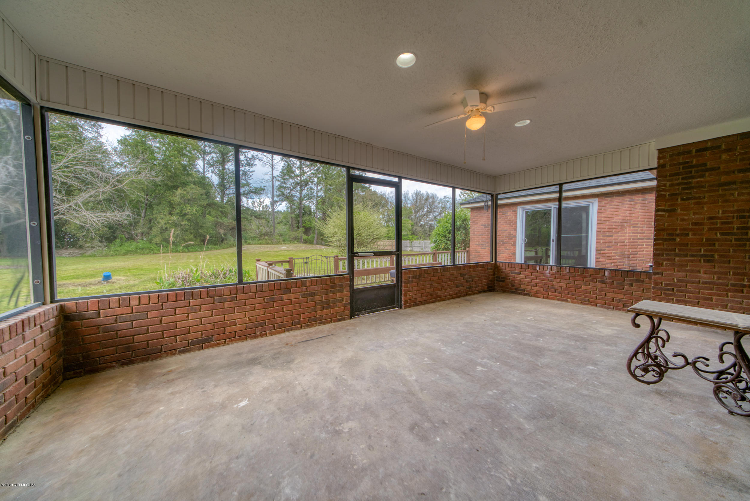 43611 Ratliff Road Callahan, FL 32011 - Photo 13 of 43 an empty room with sliding door and garden view