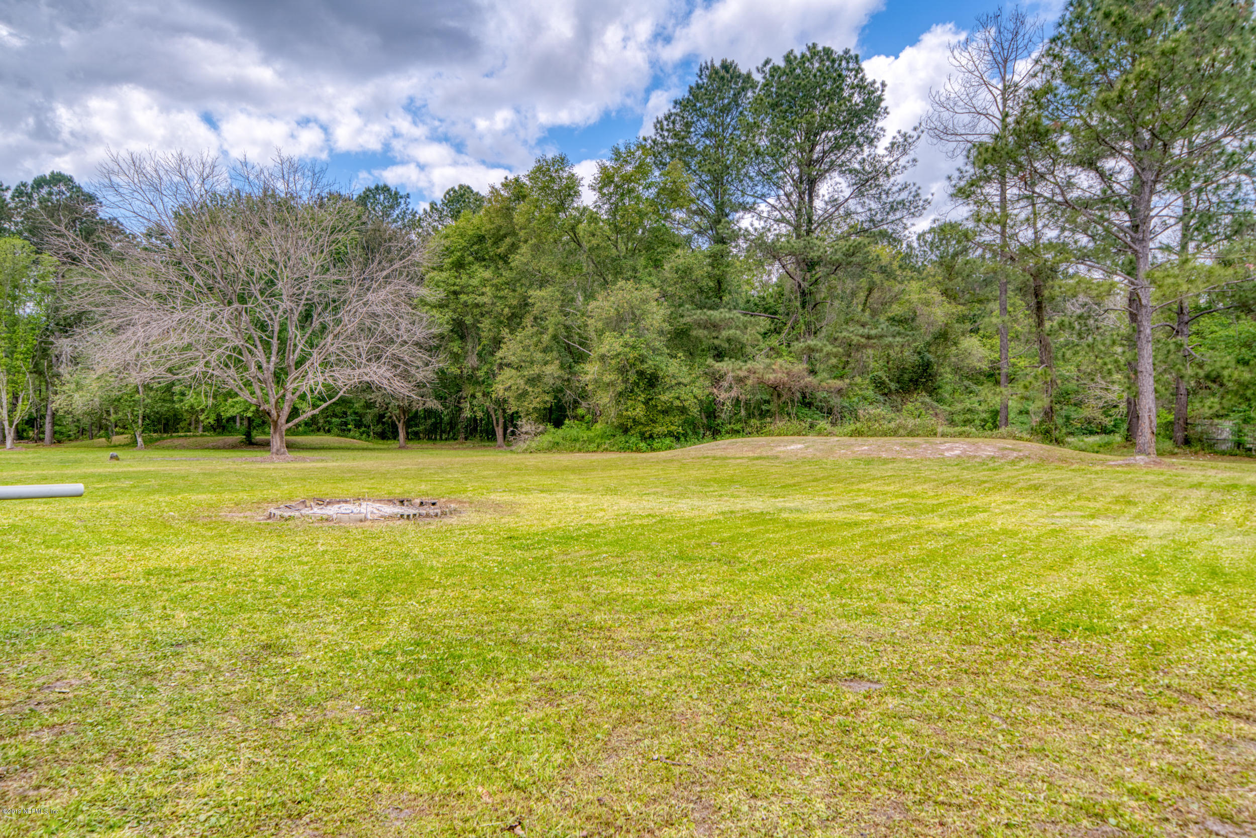 43611 Ratliff Road Callahan, FL 32011 - Photo 15 of 43 a view of a swimming pool with an outdoor space and seating area