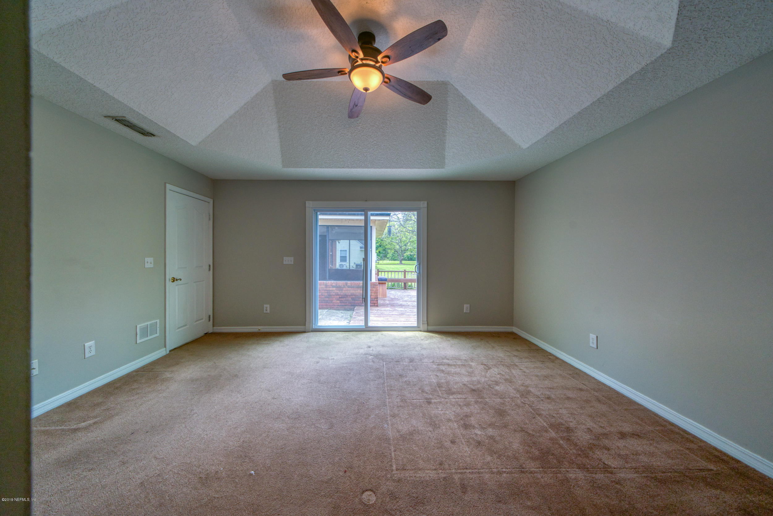 43611 Ratliff Road Callahan, FL 32011 - Photo 33 of 43 an empty room with closet and a ceiling fan