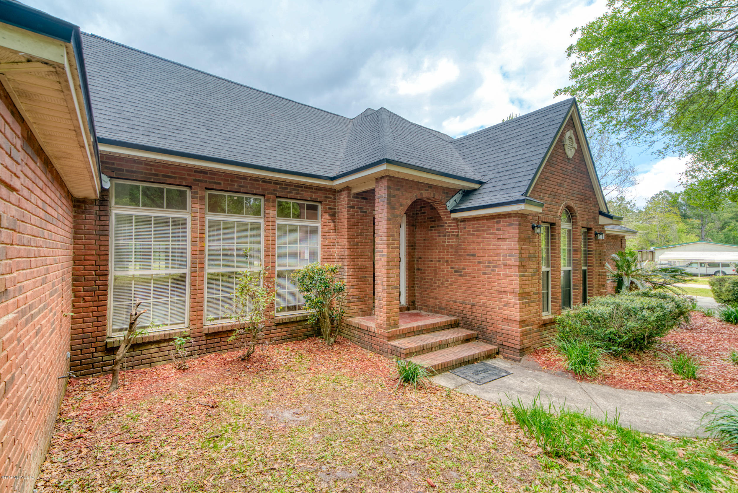 43611 Ratliff Road Callahan, FL 32011 - Photo 5 of 43 a front view of a house with garden