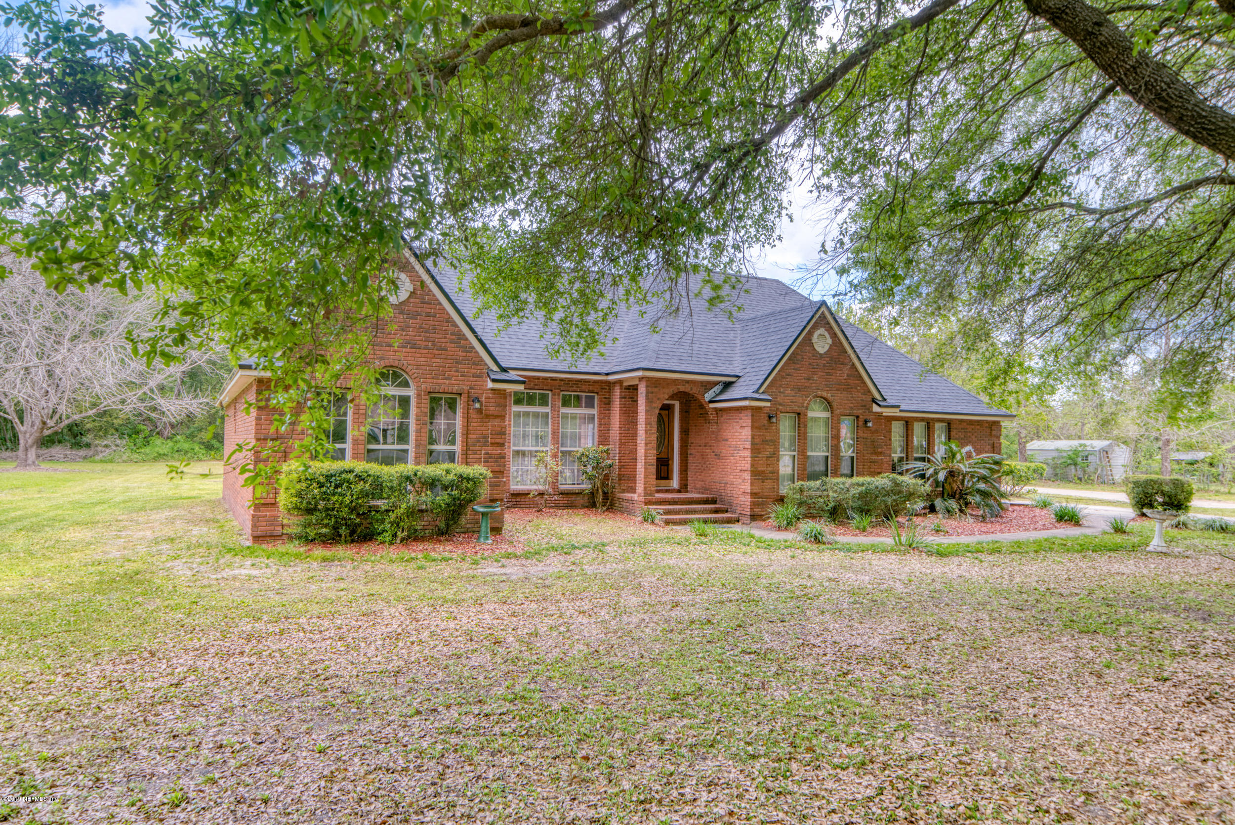 43611 Ratliff Road Callahan, FL 32011 - Photo 6 of 43 a front view of a house with a yard and garage