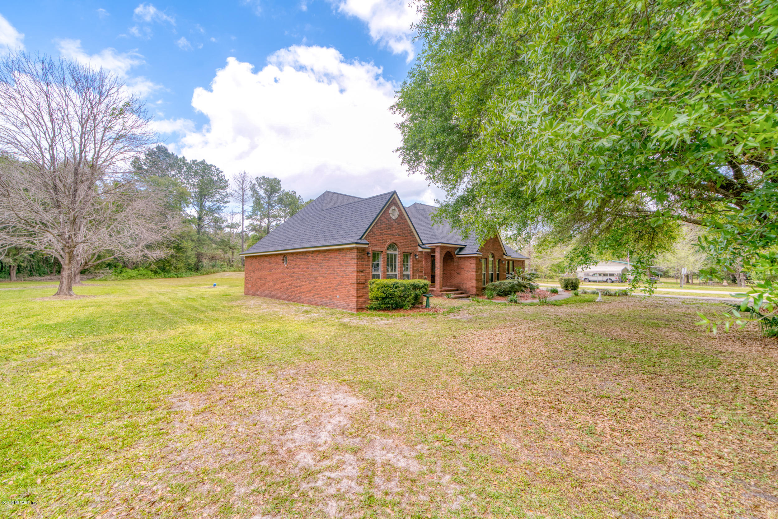 43611 Ratliff Road Callahan, FL 32011 - Photo 7 of 43 a view of a house with a yard and garage