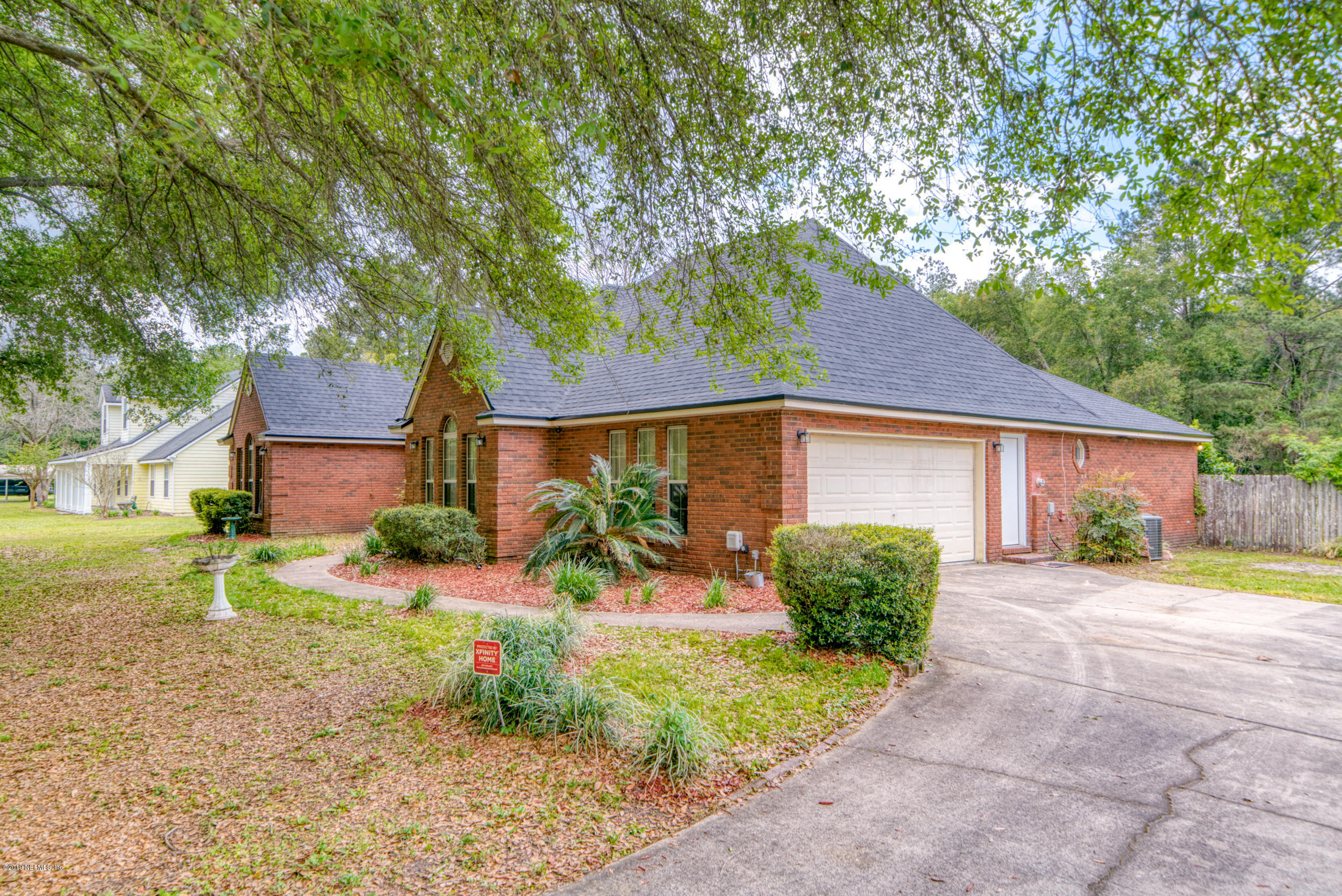 43611 Ratliff Road Callahan, FL 32011 - Photo 9 of 43 a front view of a house with a yard and a garage