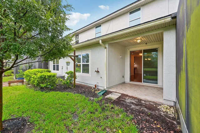 a view of a house with a backyard