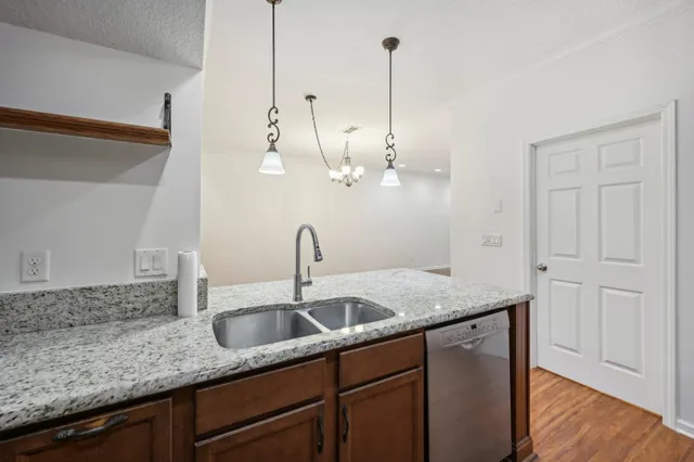 a kitchen with sink and chandelier
