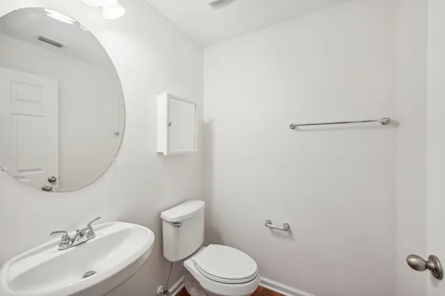 a bathroom with a sink mirror and toilet