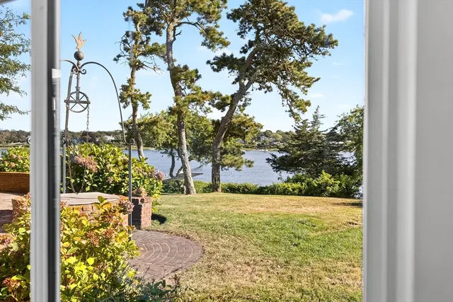 a view of a yard with yellow house