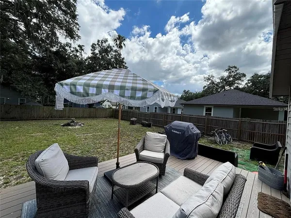 a view of a patio with couches chairs and a fire pit