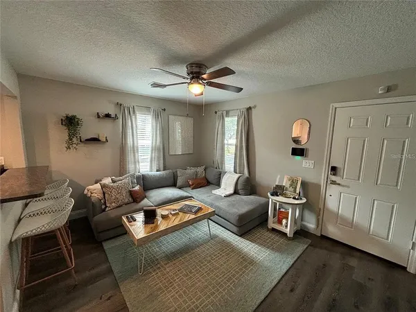 a living room with furniture and a chandelier