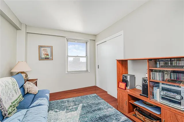 a bedroom with furniture and a book shelf