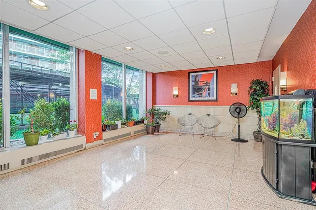 a lobby with furniture and window