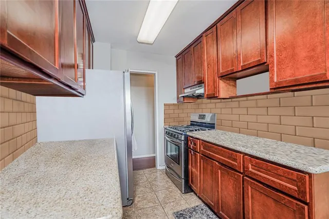 a kitchen with stainless steel appliances granite countertop a stove a sink and dishwasher