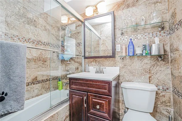 a bathroom with a sink a toilet and a shower