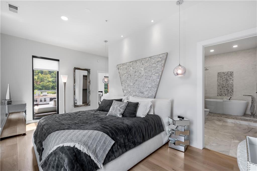 2545 Penn Avenue, Unit 601 Pittsburgh, PA 15222 - Photo 37 of 48 a bedroom with a large bed and a couch