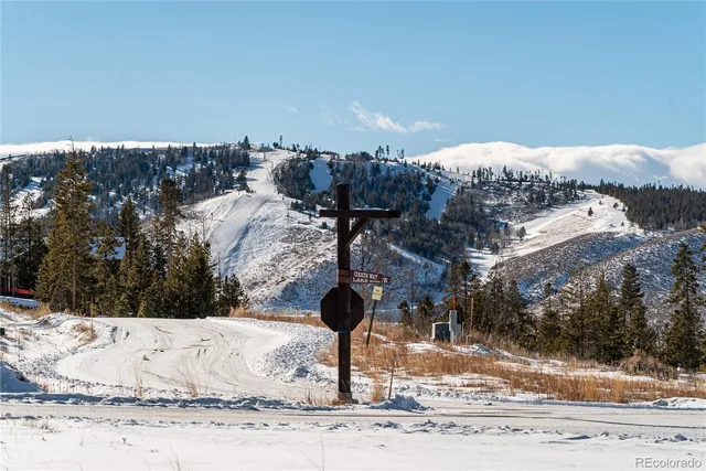 a kitchen with stainless steel appliances kitchen island granite countertop a table chairs in it and wooden floors