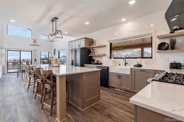 a kitchen with stainless steel appliances granite countertop white cabinets and a stove