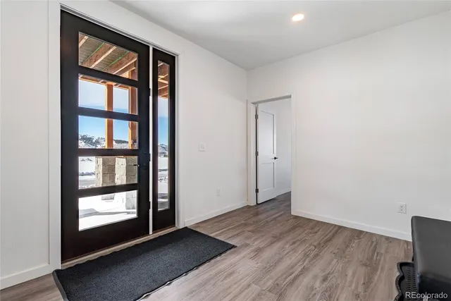 a room with wooden floor and gym equipment