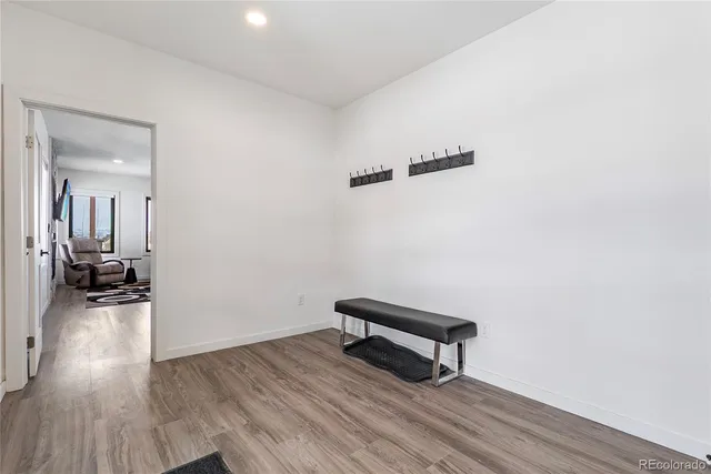 a room with wooden floor and lounge chair