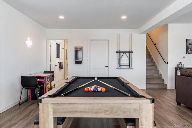 a bathroom with a granite countertop sink toilet a large mirror a shower and bathtub