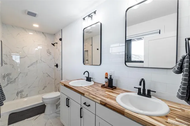 a kitchen with a sink a refrigerator and window