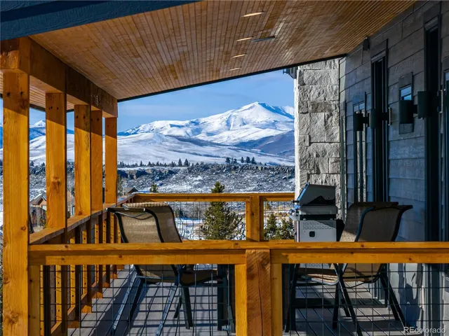 a view of a balcony with furniture and wooden floor