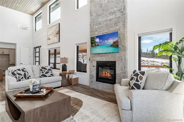 a living room with furniture couches and a large window