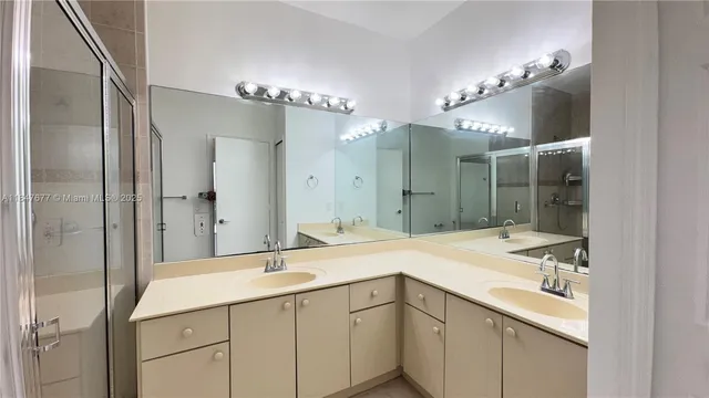 a bathroom with a sink vanity and a mirror