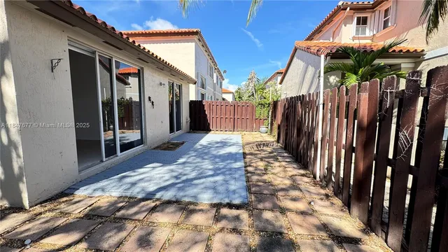 a view of a house with a wooden floor and a yard