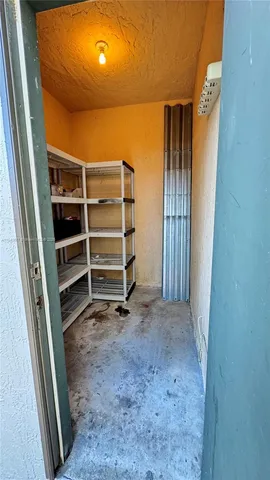 a view of an empty room with a fireplace