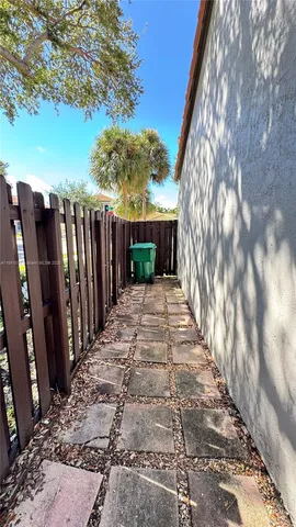 a view of a backyard with wooden fence