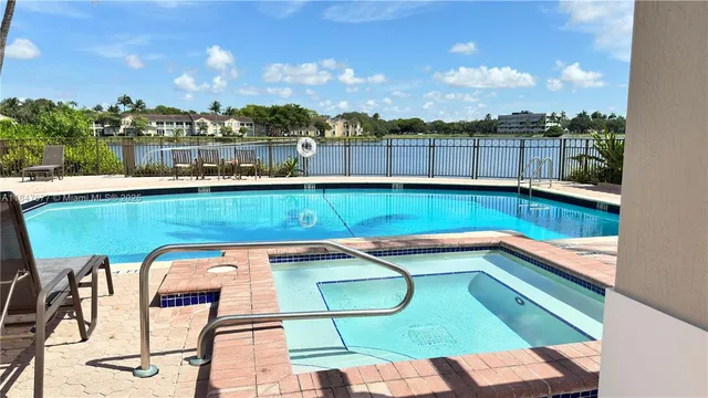 a view of swimming pool with outdoor seating and yard in back