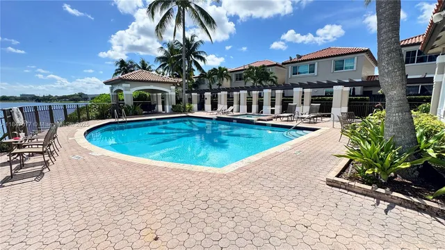a view of a house with swimming pool and sitting area