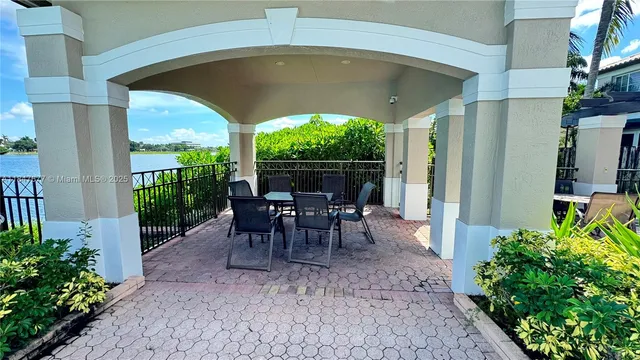 a view of a porch with chairs and backyard